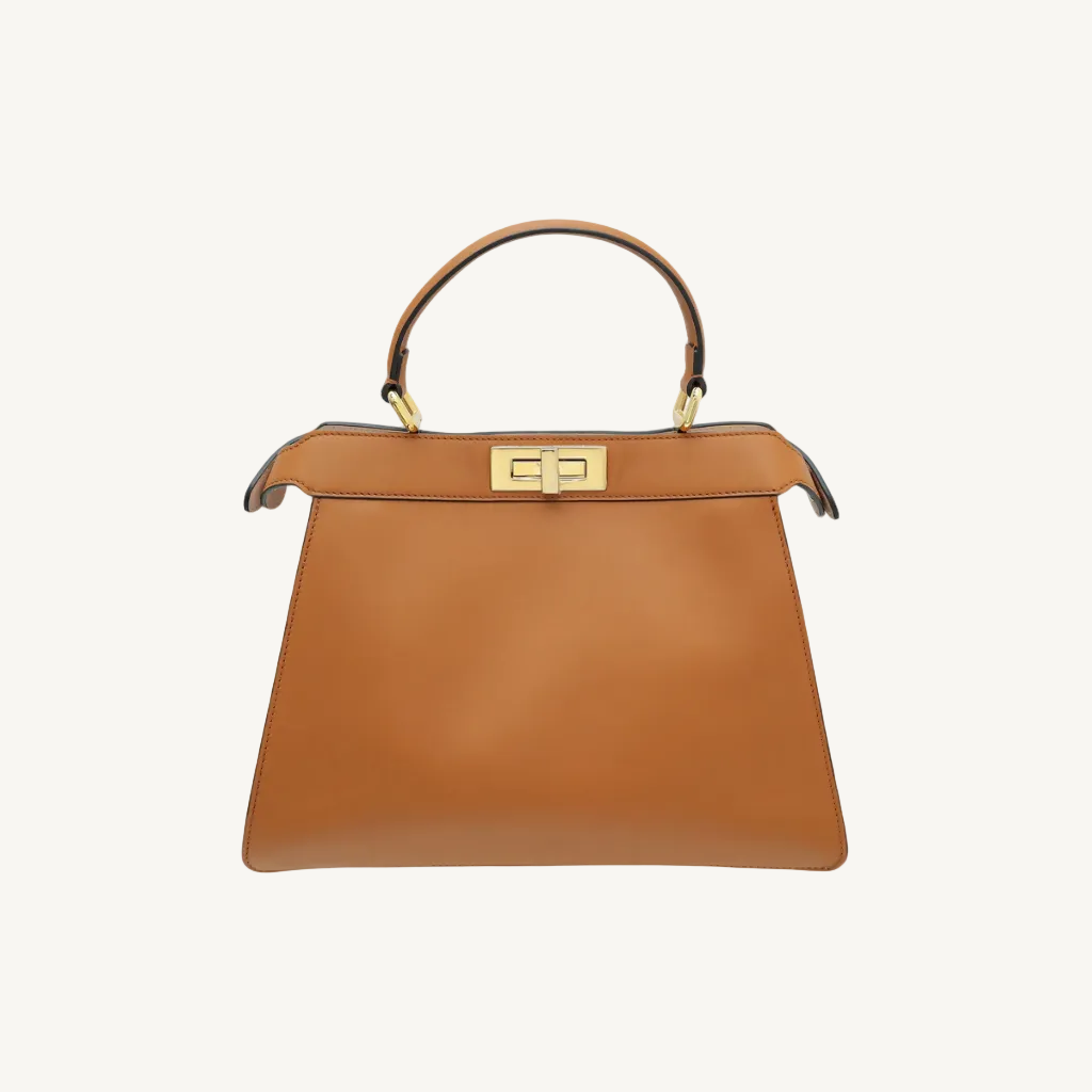 Brown handbag with gold handle and clasp on a white background