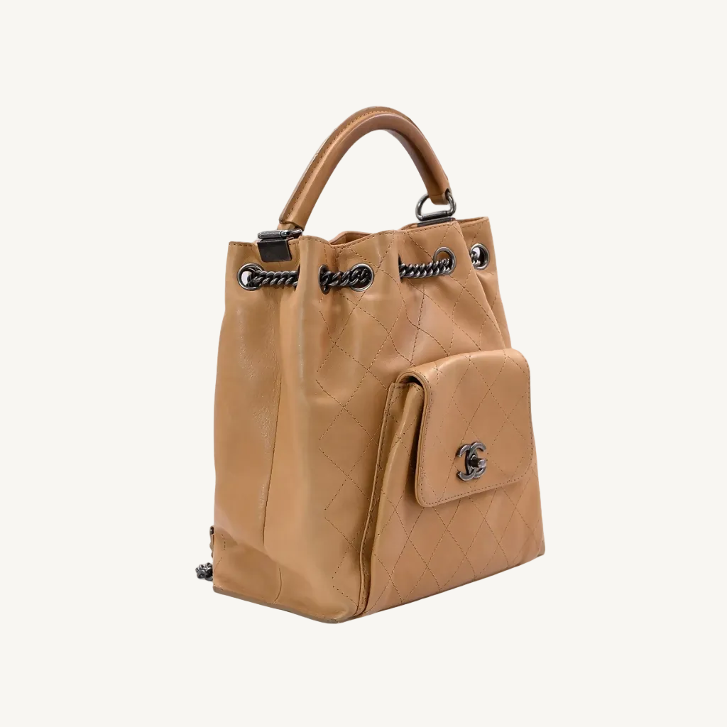 Tan leather handbag with chain details on a white background